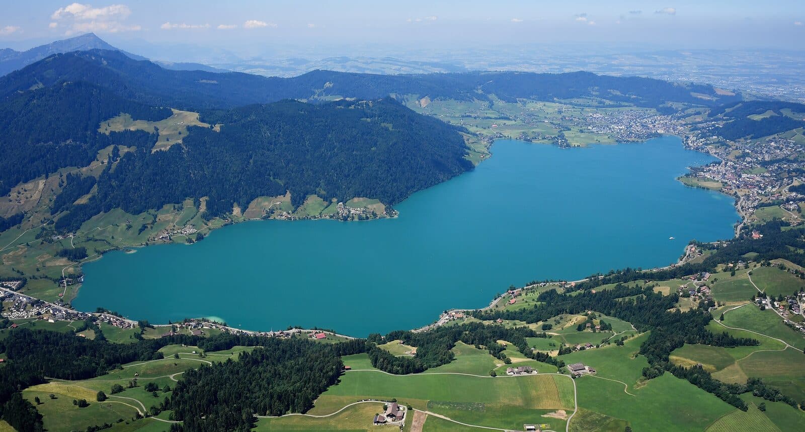 Aerial view of Lake Ägeri among green hills and farmland